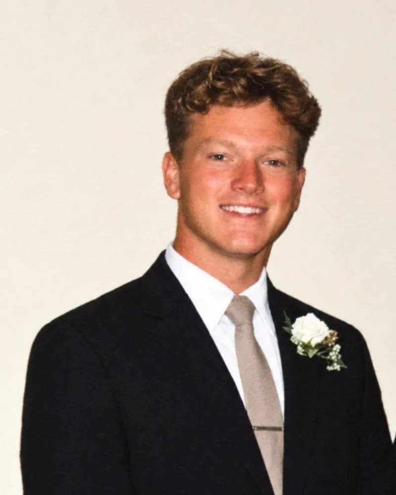 Joe Young, owner of Young SEO, in a dark suit with a white boutonnière
